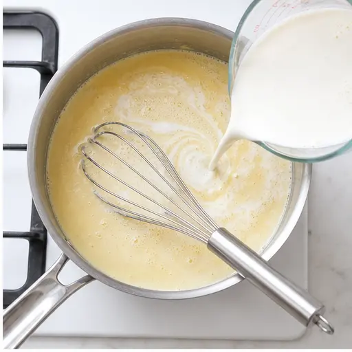 Step 2: Whisking in milk and cream for the bechamel