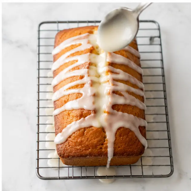 Step 4: Drizzle glossy lemon glaze over loaf