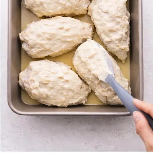 Step 2: Spreading the coating over the raw chicken fillets