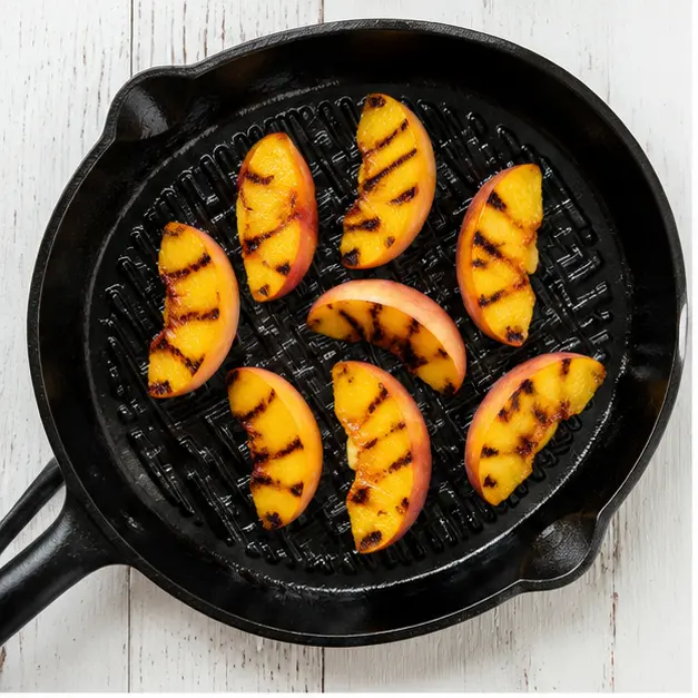 Step 1: Caramelizing peach wedges on a hot grill pan