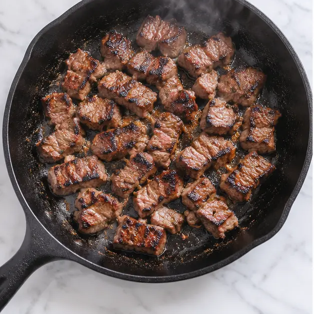 Step 3: Searing the diced carne asada in a hot skillet