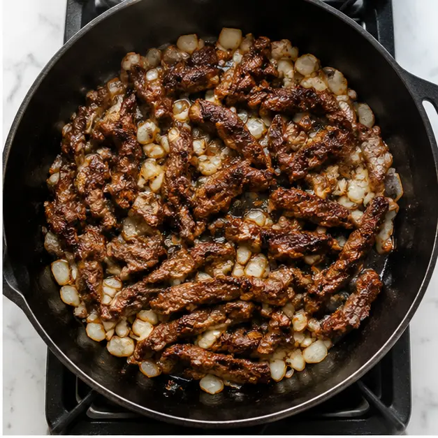 Step 2: Browning the steak and onions in a skillet