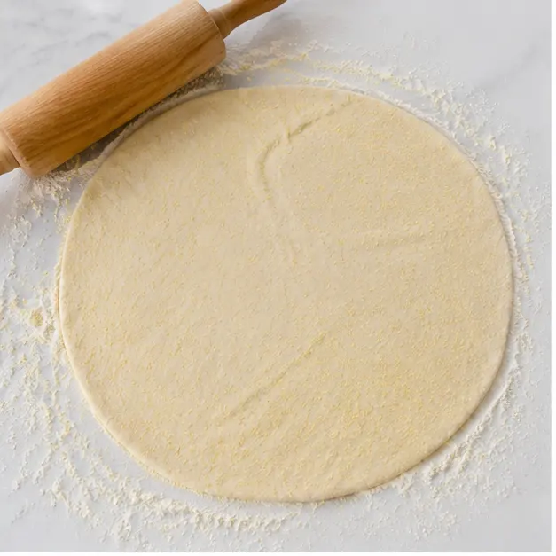 Step 1: Rolling out the cornmeal dough into a 13-inch disk