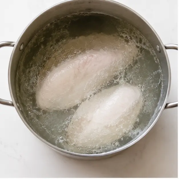 Step 1: Boil chicken in salted water until cooked through.