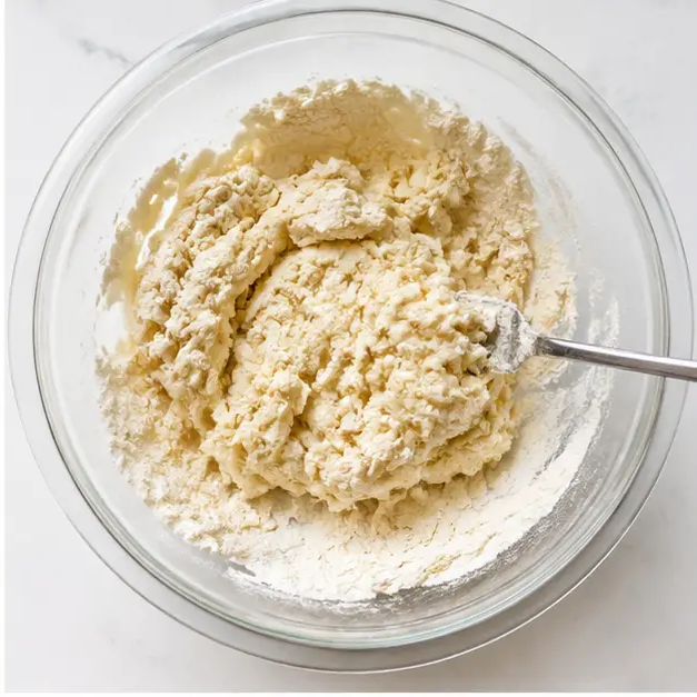 Step 2: Mix self-rising flour, oil, egg, and water into a shaggy dough.