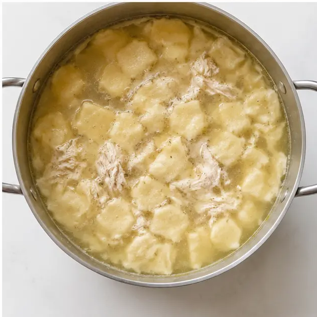 Step 4: Add dumplings and shredded chicken to simmering broth.