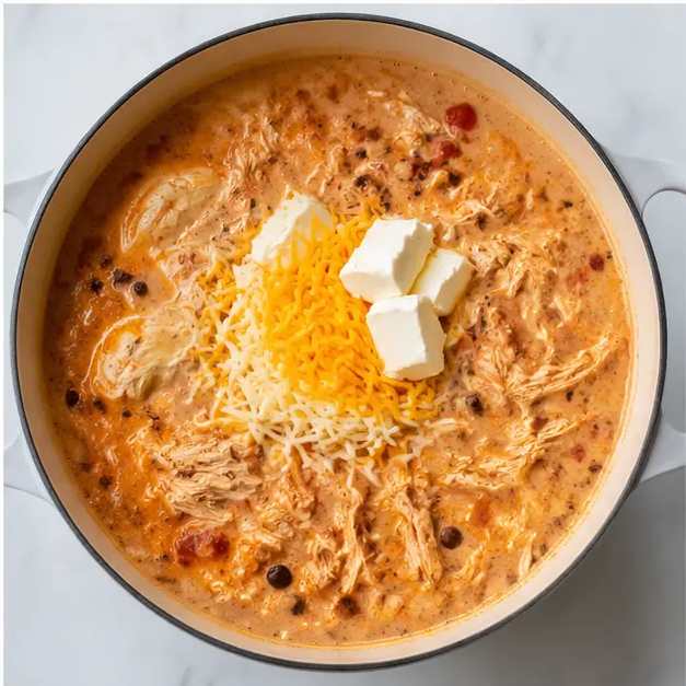 Step 4: Shred chicken and stir in cream cheese and shredded cheeses