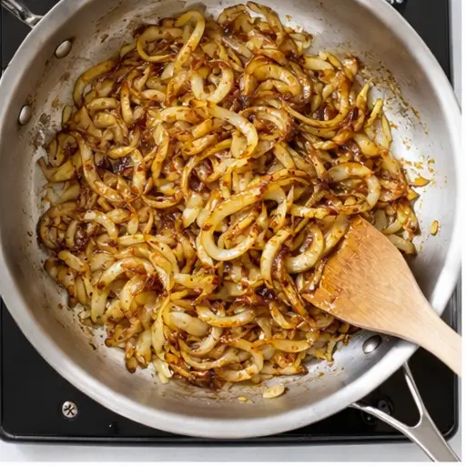 Step 1: Caramelizing sliced yellow onions in butter and olive oil