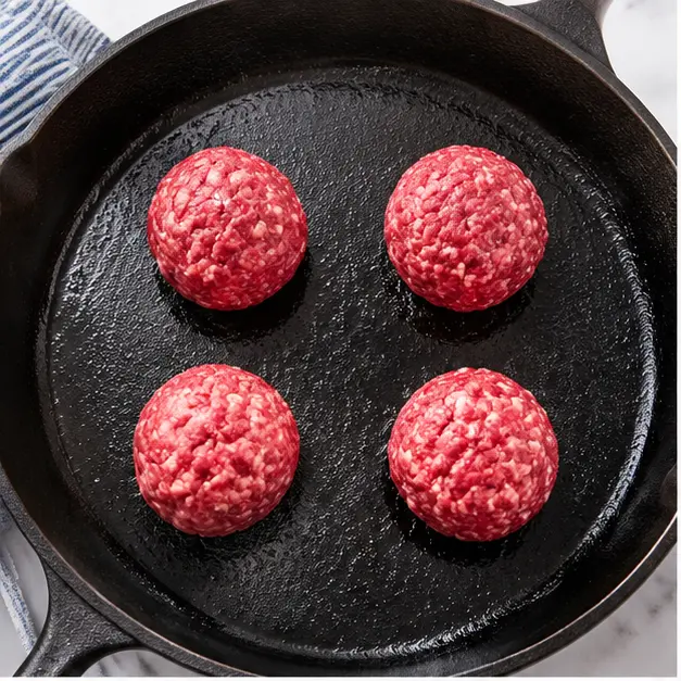 Step 1: Placing cold beef balls on hot cast iron