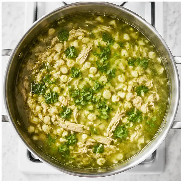 Step 4: Return shredded chicken and hominy to the pot for final simmer