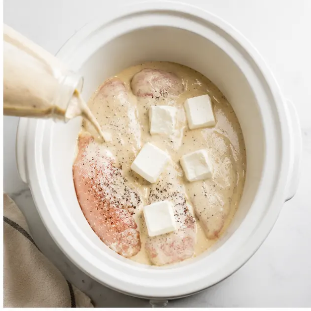 Step 2: Pouring creamy parmesan garlic sauce over chicken