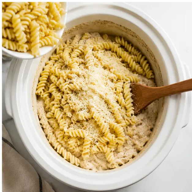 Step 4: Stirring cooked rotini pasta into creamy sauce