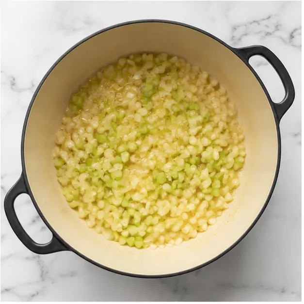 Step 1: Sautéing diced onion and celery in olive oil