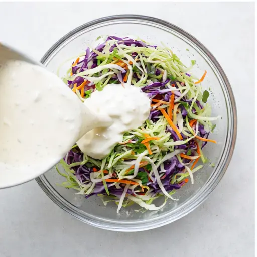 Step 3: Toss shredded cabbage slaw with creamy dressing