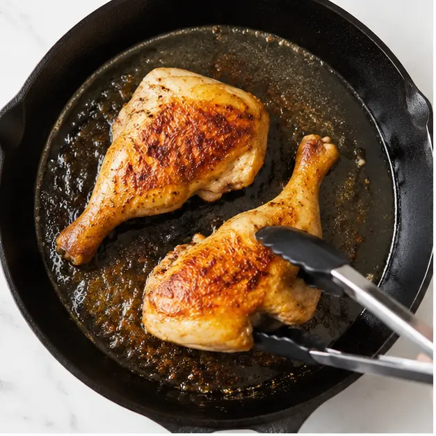 Step 1: Searing chicken leg pieces skin-side down until golden