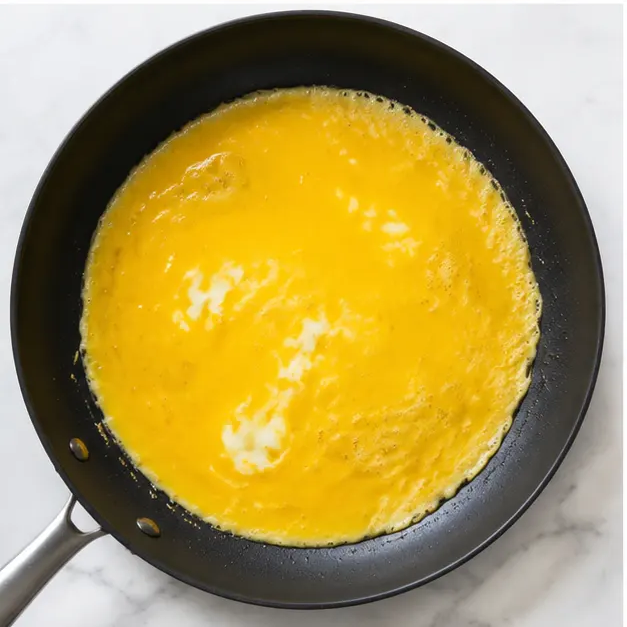 Step 3: Pour beaten eggs into the skillet