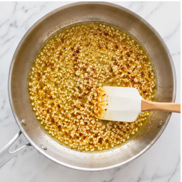 Step 3: Sautéing minced garlic and red pepper flakes in butter