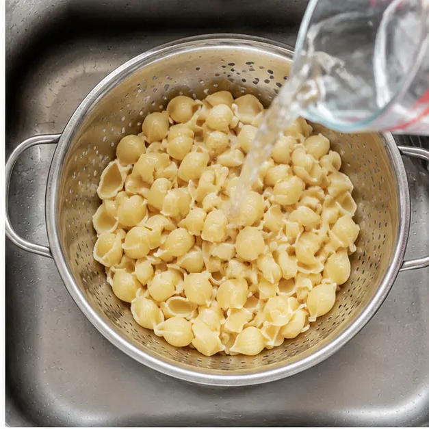 Step 2: Draining and rinsing the pasta under cold water