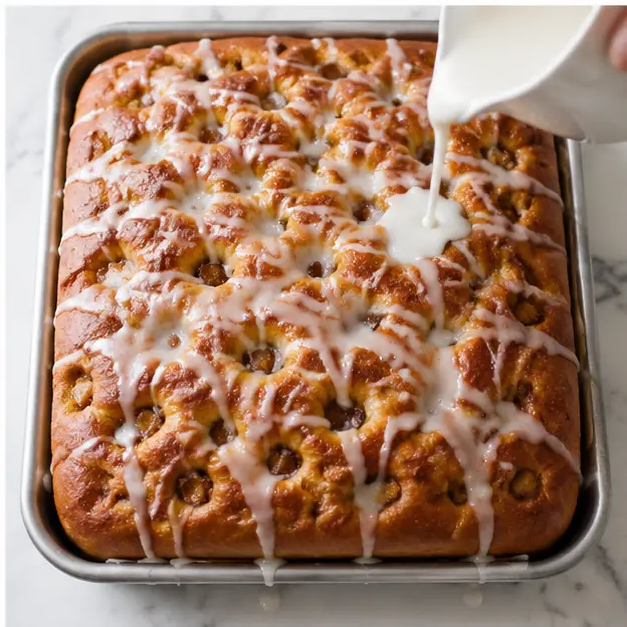 Step 4: Drizzle the vanilla glaze over the warm baked focaccia so it pools in the dimples.