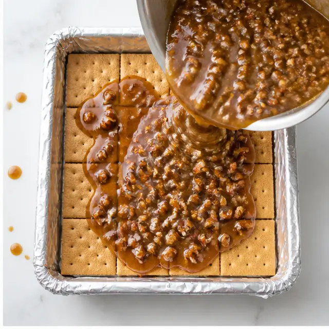 Step 2: Add pecans and pour over graham crackers