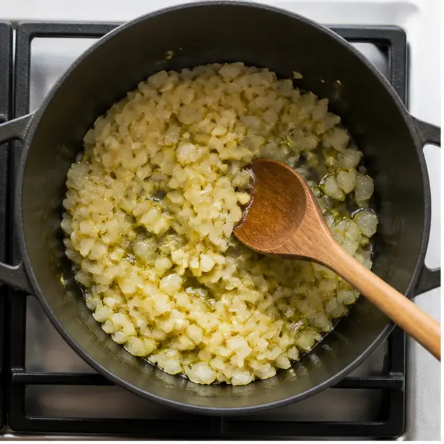 Step 1: Sauté diced yellow onion and minced garlic in olive oil until soft and translucent