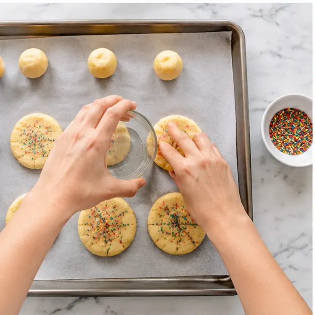 Scoop dough into balls, flatten, and add sprinkles