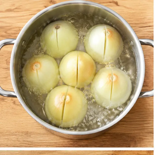 Step 1: Parboiling whole yellow onions with a slit down one side in salted water