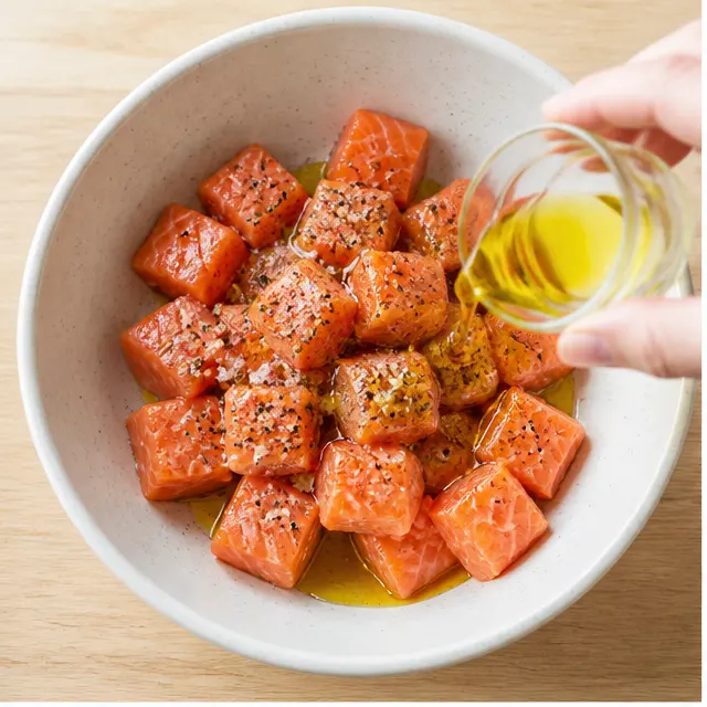 Step 1: Toss the cubed salmon with oil, salt and pepper