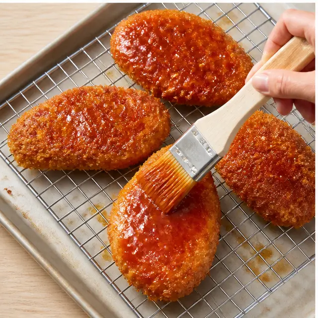 Step 3: Brushing baked golden fillets with hot honey butter glaze