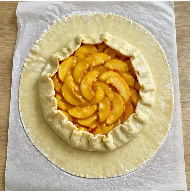 Step 3: Folding the pastry edges over the peach filling in pleats