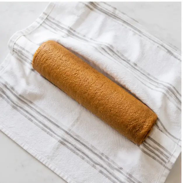Roll the warm cake in a towel