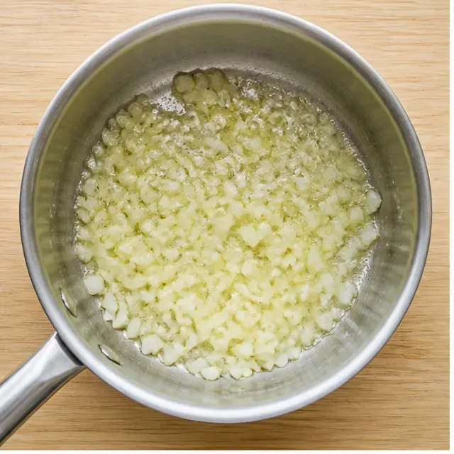 Step 1: Sautéing diced onion in melted butter until translucent