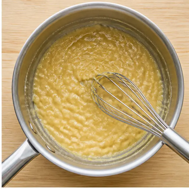 Step 2: Whisking flour into the butter to form a smooth roux